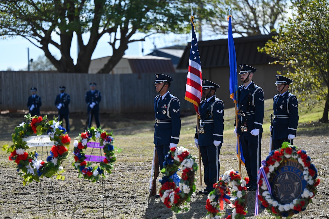 Airmen of the Blue Knights Honor Guard from Altus Air Force Base, stand at attention at the Jackson County War Memorial at Altus, Oklahoma, Nov. 11, 2024. The Blue Knights performed TAPS and a 21-gun salute during a ceremony in honor of Veterans Day. (U.S. Air Force photo by Airman 1st Class Lauren Torres)