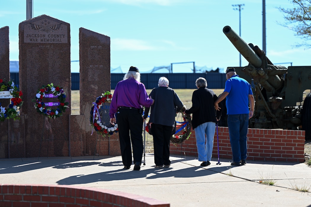 Members of the VFW Post 4876 lay wreaths in honor of Veterans Day at the Jackson County War Memorial at Altus, Oklahoma, Nov. 11, 2024. A wreath-laying ceremony is a formal way to honor and remember those who have served and died, and to show commitment to their memory. (U.S. Air Force photo by Airman 1st Class Lauren Torres)