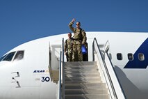 9th Reconnaissance Wing leaders wave to a crowd of family and friends before boarding a Boeing 767-300 from the flightline on Beale Air Force Base, California, Sept. 27, 2024