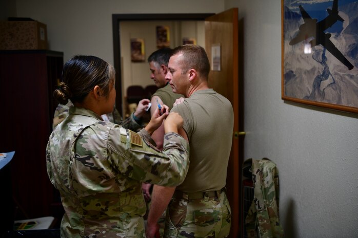 U.S. Air Force Chief Master Sgt. Steven Creek, 9th Reconnaissance Wing command chief, receives a flu shot as part of the pre-deployment function (PFD) line on Beale Air Force Base, California, Sept. 24, 2024.