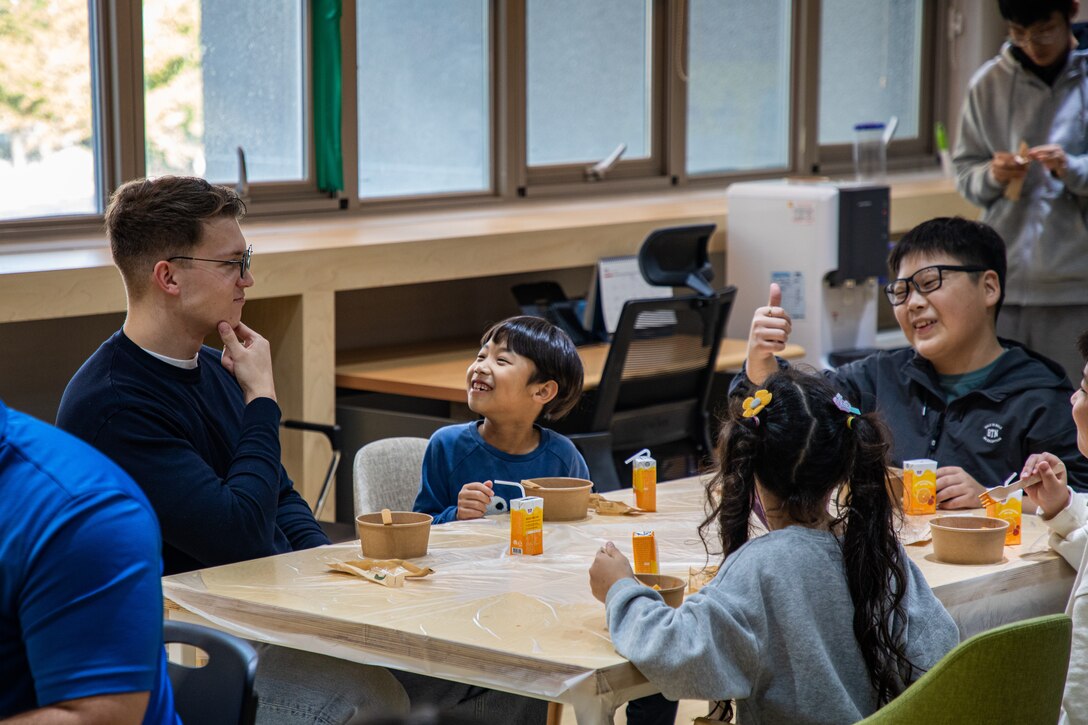 U.S. Marine Corps Sgt. Ethan Franks, left, an ammunition chief with U.S. Marine Corps Forces Korea, engages with South Korean children during a volunteer event with the Korea Land and Housing Corporation in Pyeongtaek, South Korea, Oct. 24, 2024. U.S. Marines with MARFORK foster relationships and support the local community by volunteering and interacting with South Korean children. (U.S. Marine Corps photo by Cpl. Dean Gurule)