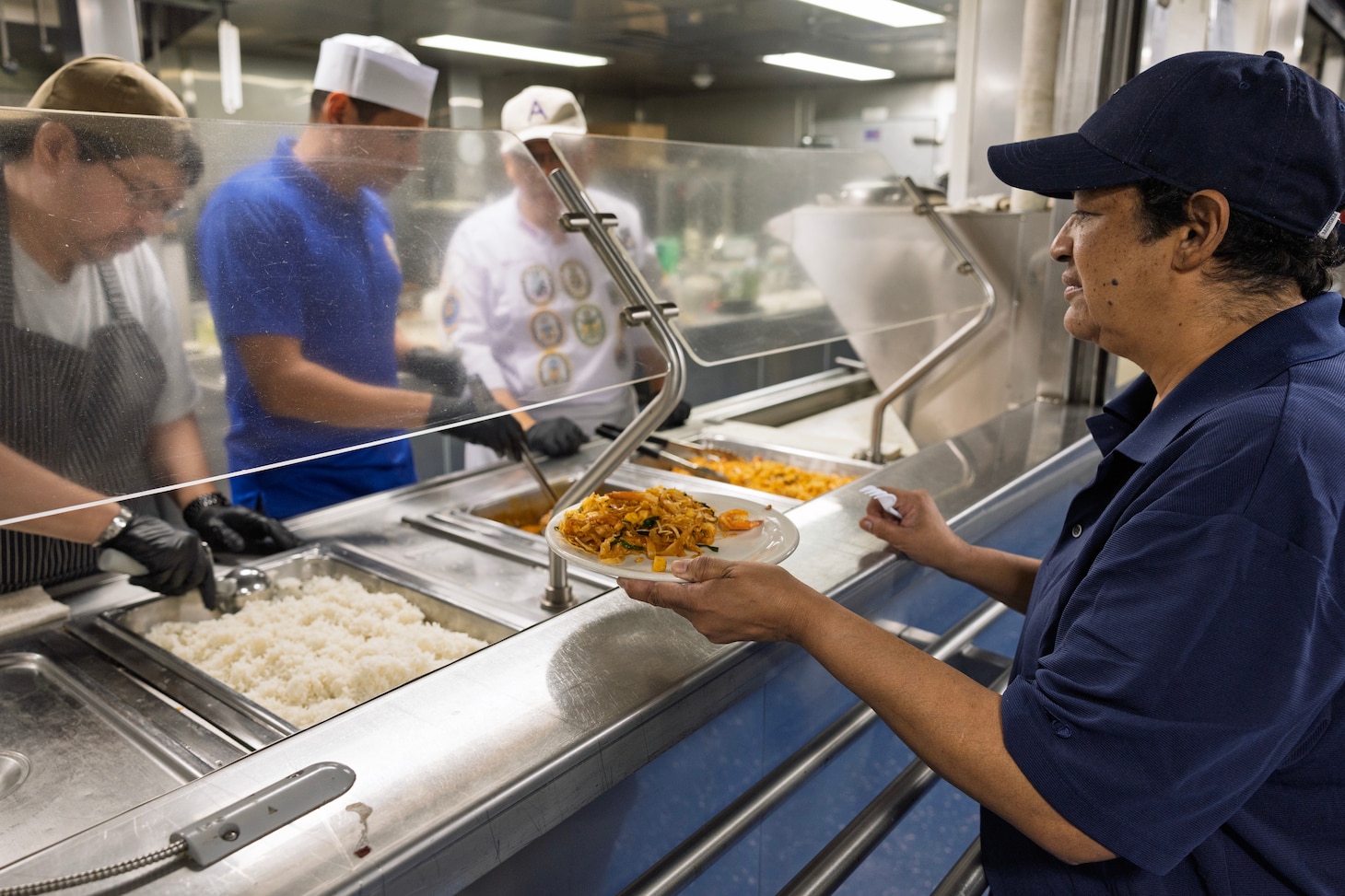 SRIRACH, Thailand—Civilian mariner Carmen Anton, steward utilityman, expeditionary fast transport ship USNS City of Bismarck (T-EPF 9), collects her lunch at the galley aboard City of Bismarck in Sriracha, Thailand, Nov. 6, 2024. (U.S. Navy photo by Grady T. Fontana)