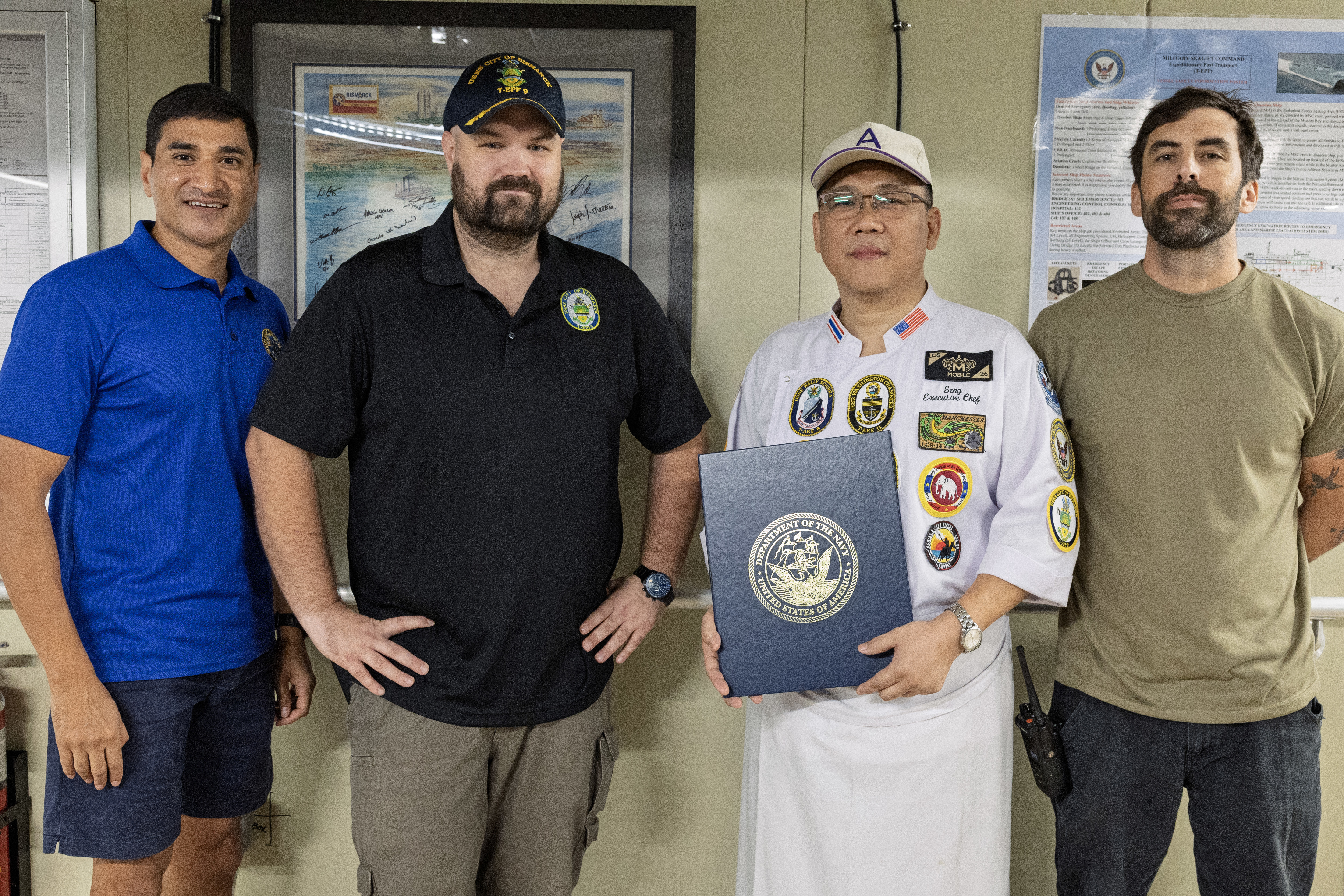 SRIRACH, Thailand— U.S. Navy Lt. Cmdr. Jamil A. Khan, left, chaplain, MSC Far East; civilian mariner Capt. Chris Jackson, ship’s master, expeditionary fast transport ship USNS City of Bismarck (T-EPF 9); Pongpisit Ungsuchaikij, head chef at a popular hotel in Pattaya, Thailand; and civilian mariner Colin B. Smith, chief mate, City of Bismarck; pose for a photograph aboard City of Bismarck in Sriracha, Thailand, Nov. 6, 2024. Ungsuchaikij was presented with a letter of appreciation for his volunteer work with U.S. Navy League Siam Council in Pattaya, Thailand, serving the U.S. Navy. (U.S. Navy photo by Grady T. Fontana)
