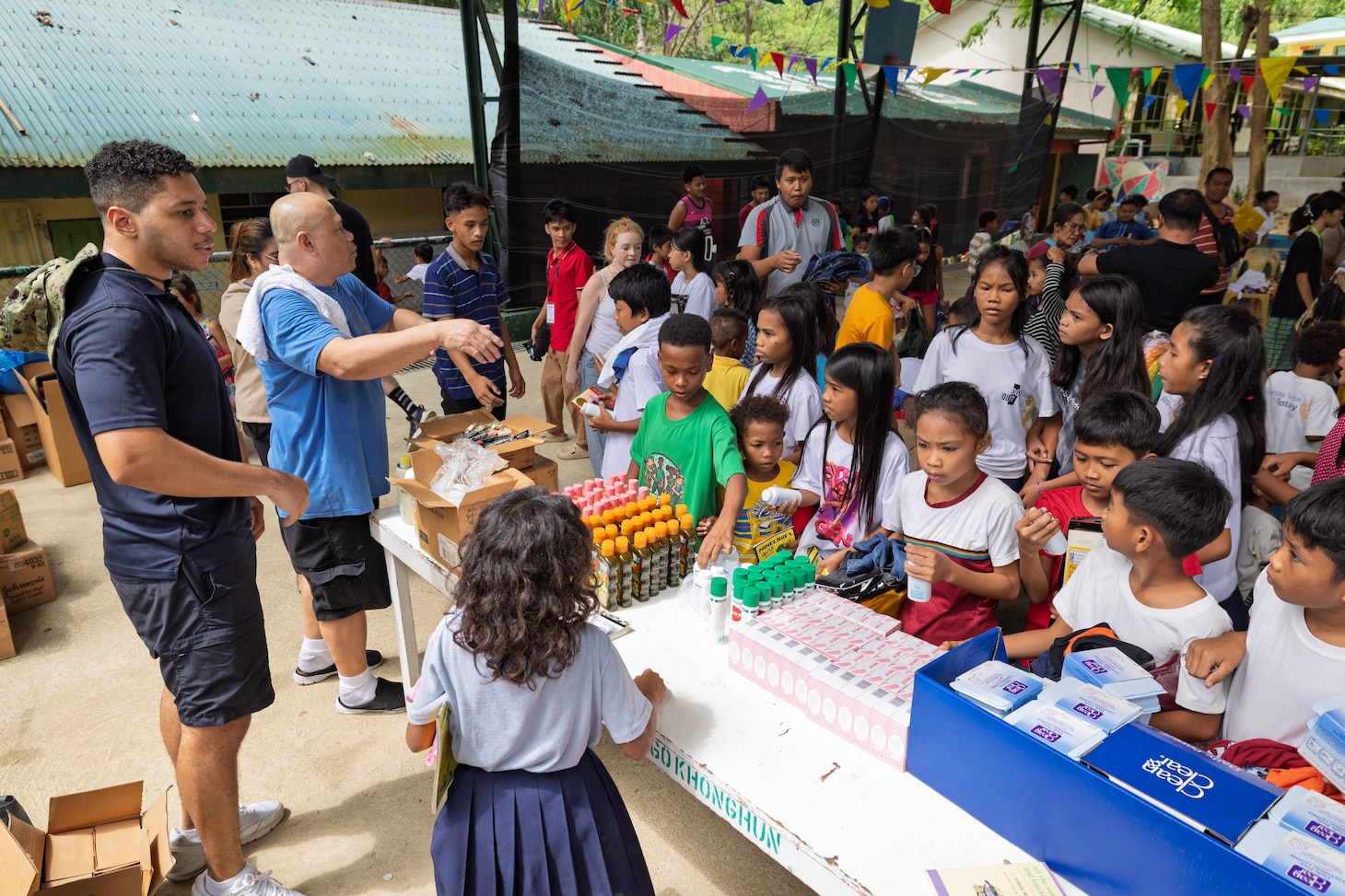 SUBIC BAY, Philippines—Yeoman 1st Class Robert J. Carter, assigned to Military Sealift Command Far East, left, and civilian mariner Celerino A. Monton, steward utility, assigned to expeditionary fast transport ship USNS Puerto Rico (T-EPF 11), distribute donated goods to Aeta students during a community outreach event at the Aningway-Sacatihan Elementary School Annex/ High School, Subic Bay, Philippines, Oct. 29, 2024. The Aeta are indigenous people who live in scattered, isolated mountainous parts of Luzon, Philippines. (U.S. Navy photo by Grady T. Fontana)