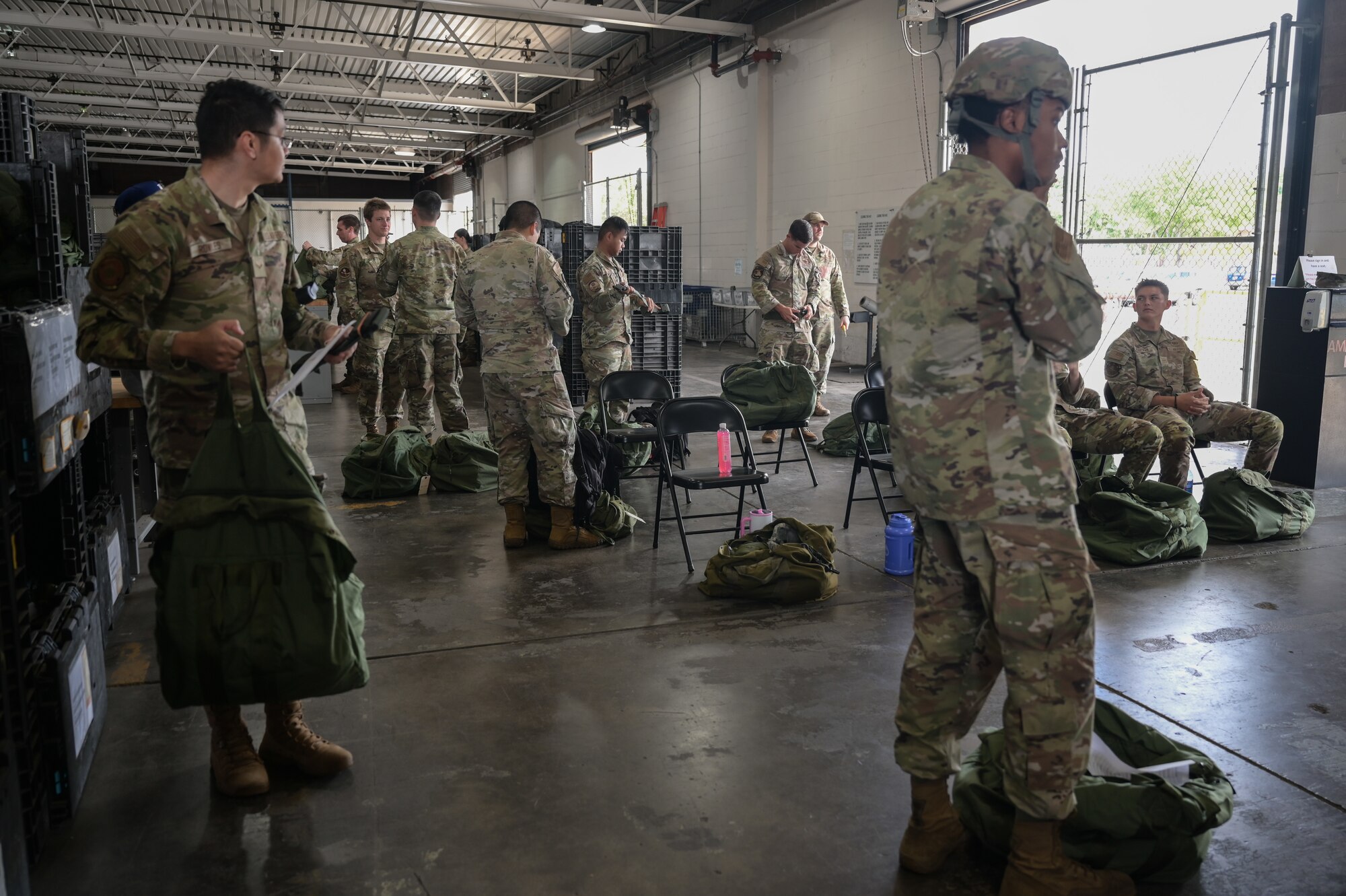Airmen go through a mobility equipment processing line.