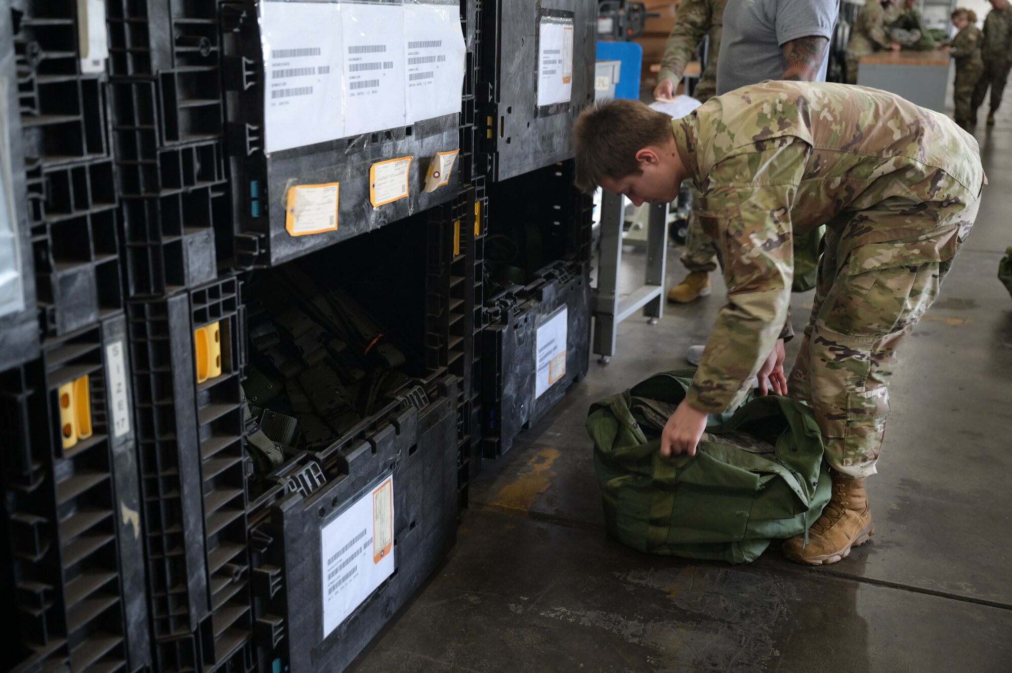 Airmen go through a mobility equipment processing line.