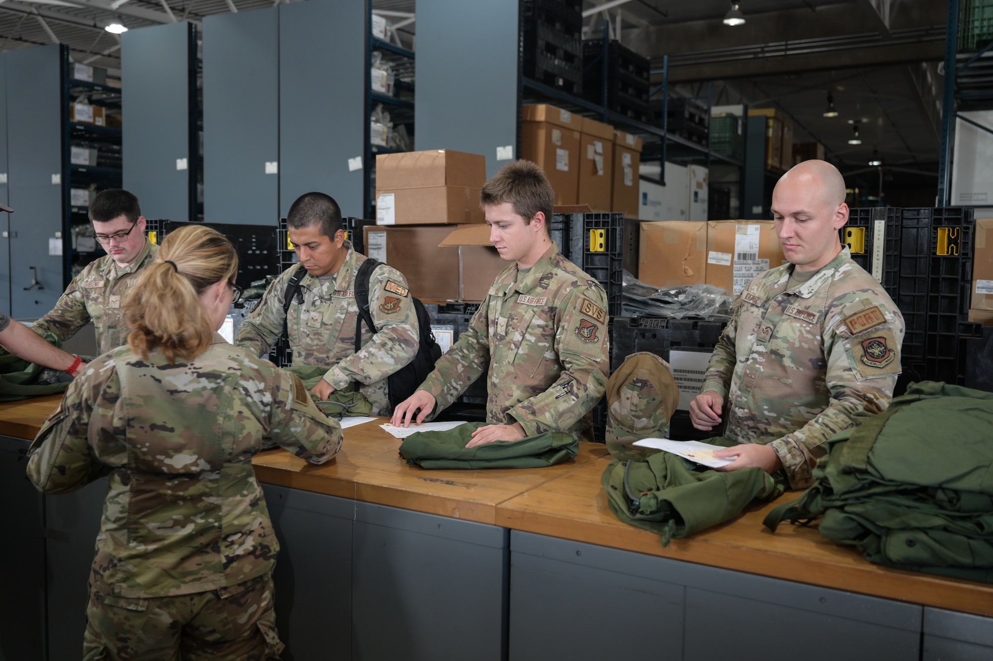 Airmen go through a mobility equipment processing line.