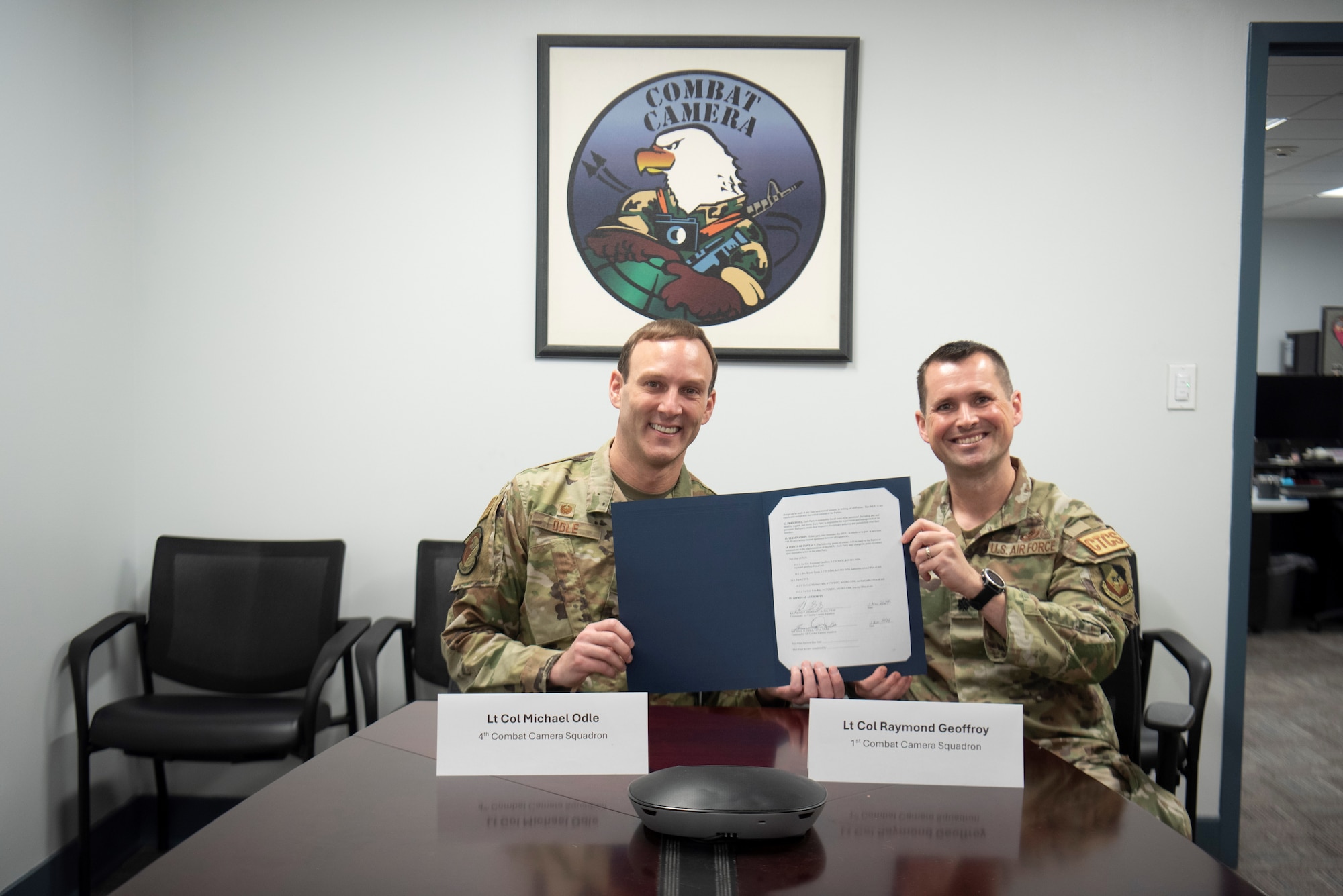 Lt Col. Michael Odle, commander of the 4th Combat Camera Squadron (4CTCS) signs a Memorandum of Understanding with Lt. Col. Raymond Geoffroy, commander of the 1st Combat Camera Squadron (1CTCS) on Nov. 2, 2024 at Joint Base Charleston, S.C.