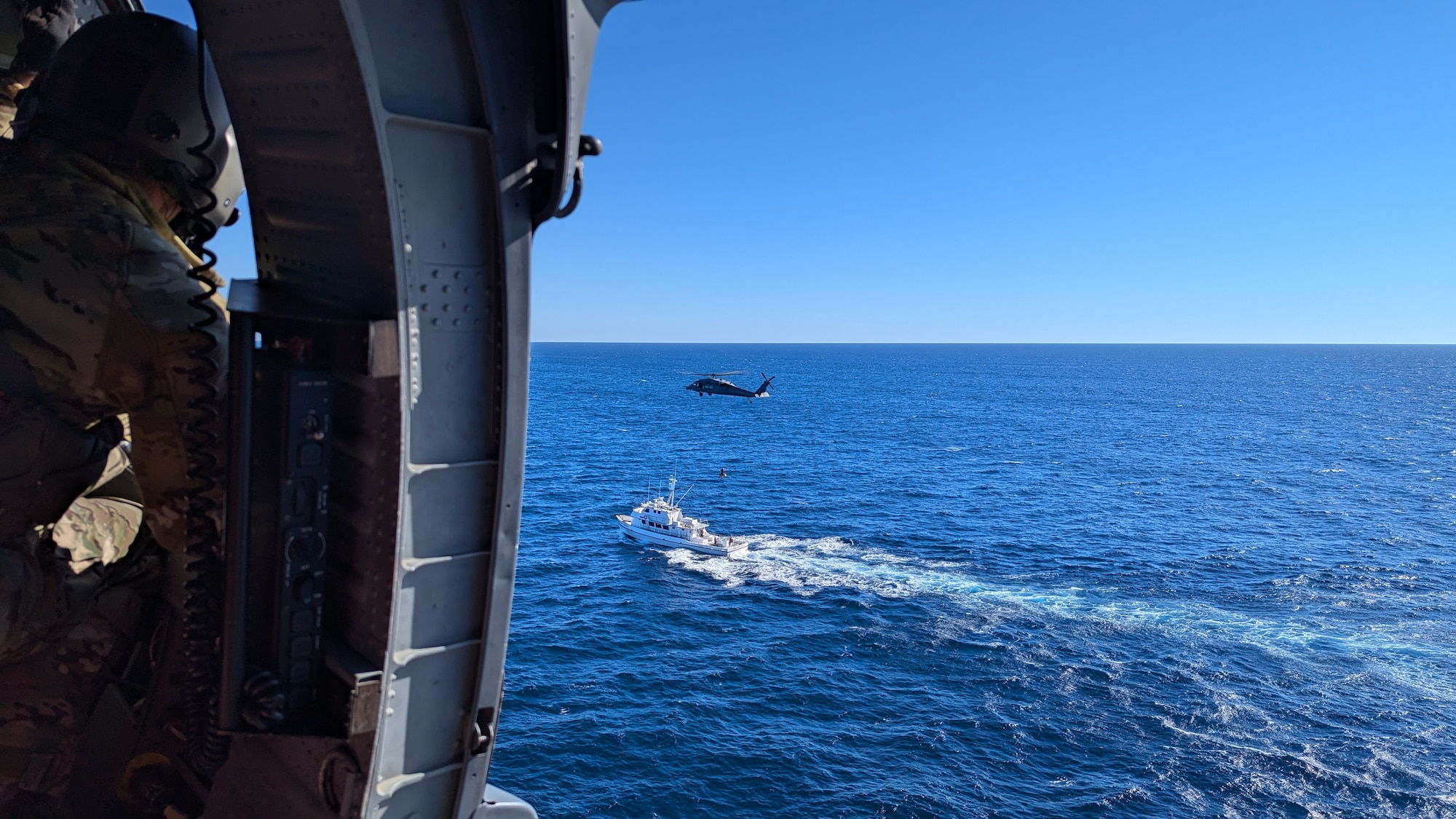A U.S. Air Force HH-60G Pave Hawk rescue helicopter assigned with the 129th Rescue Squadron, 129th Rescue Wing, California Air National Guard, hovers over a fishing vessel to evacuate an ill fisherman about 400 miles off the San Diego coast Nov. 8, 2024. The patient was on a chartered fishing trip when he began experiencing stroke symptoms.