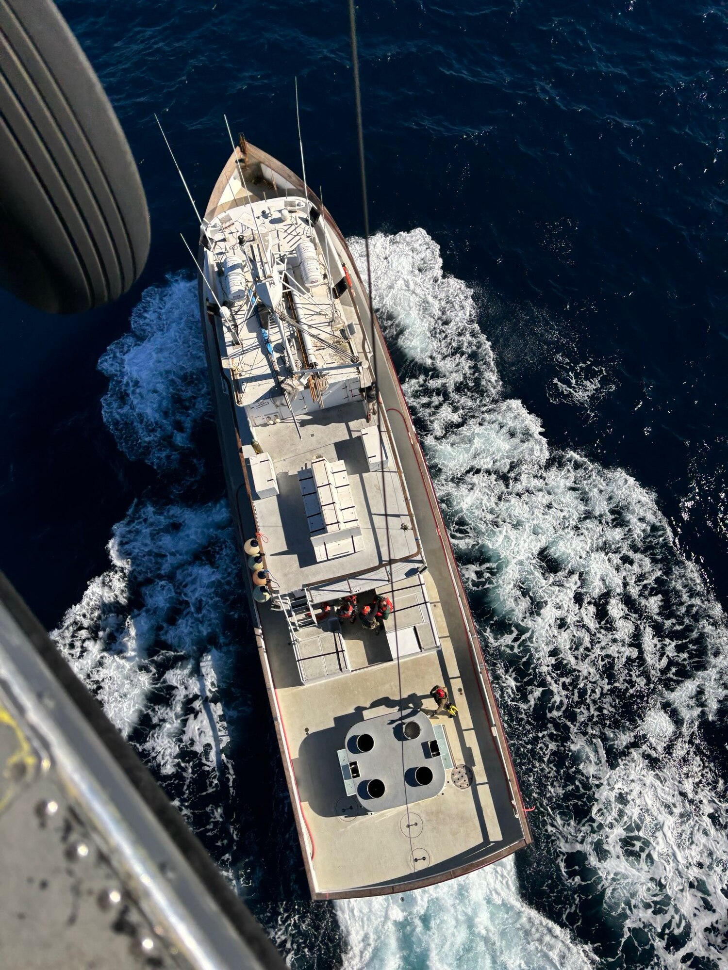A U.S. Air Force HH-60G Pave Hawk rescue helicopter assigned with the 129th Rescue Squadron, 129th Rescue Wing, California Air National Guard, hovers over a fishing vessel to evacuate an ill fisherman about 400 miles off the coast of San Diego Nov. 8, 2024. The patient was on a chartered fishing trip when he began experiencing stroke symptoms.