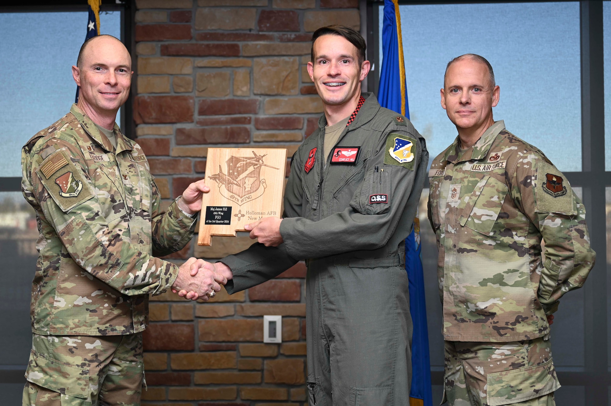U.S. Air Force Maj. James Hill, 54th Operations Support Squadron flying hour program manager, accepts the 49th Wing Field Grade Officer of the Quarter Award, during the 49th Wing’s 3rd Quarter Award ceremony at Holloman Air Force Base, New Mexico, Nov. 8, 2024. Quarterly award winners were selected based on their technical expertise, demonstration of leadership and job performance. (U.S. Air Force photo by Airman 1st Class Michelle Ferrari)
