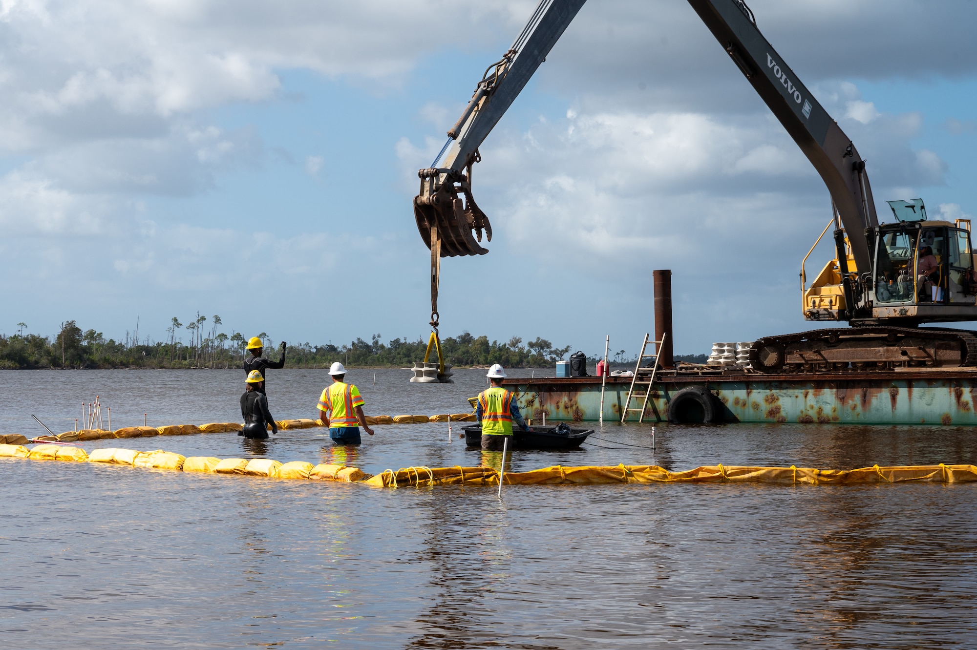 Teams of contractors install concrete modules to serve as a living reef on the coastline of Tyndall Air Force Base.