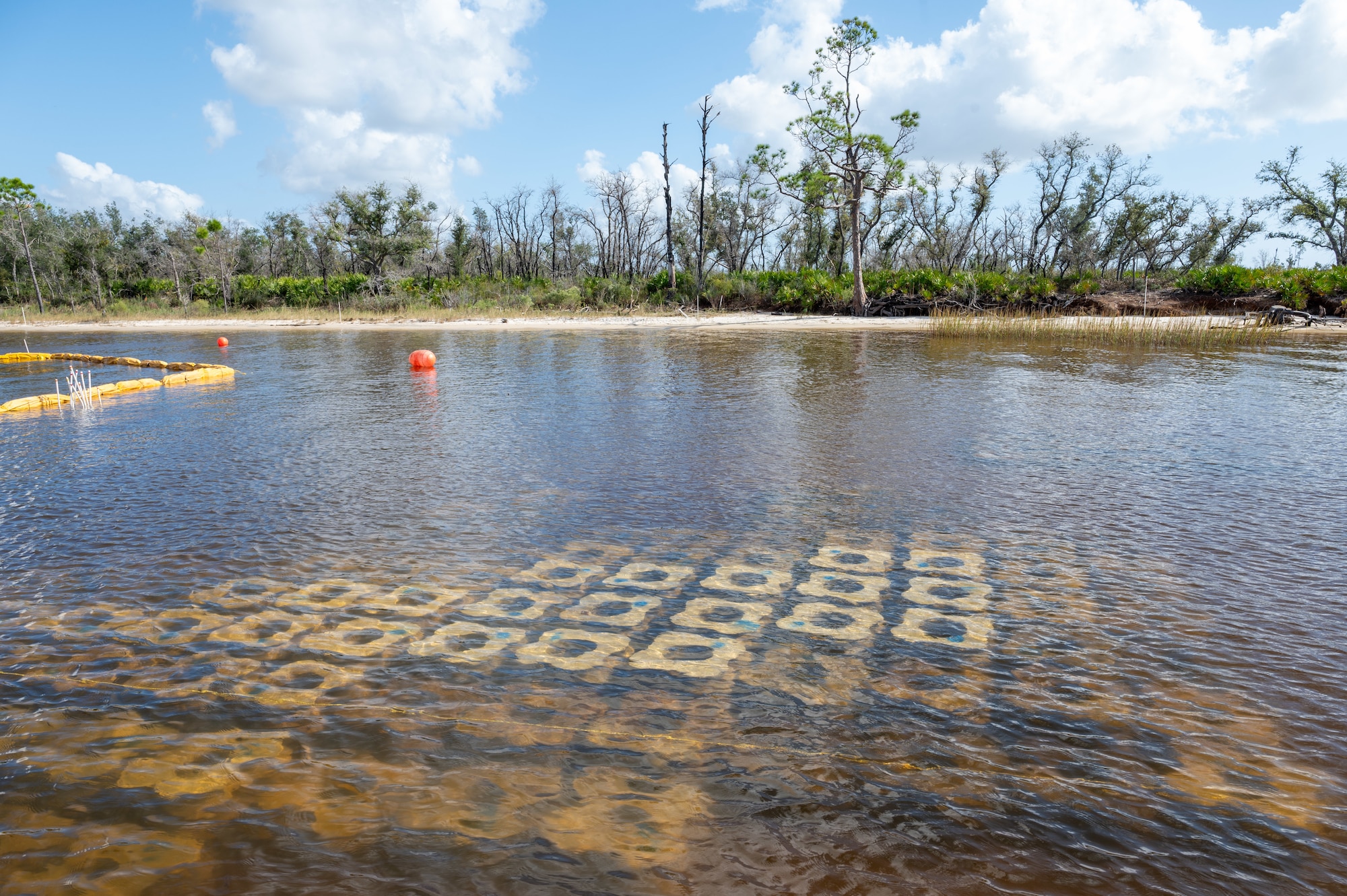 Concrete modules lay in the water near the shoreline of Tyndall Air Force Base.