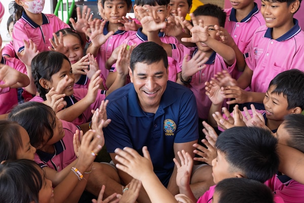 Lt. Cmdr. Jamil A. Khan is greeted by children during a community outreach event at the Learning Center of the Human Help Network Foundation in Pattaya, Thailand.