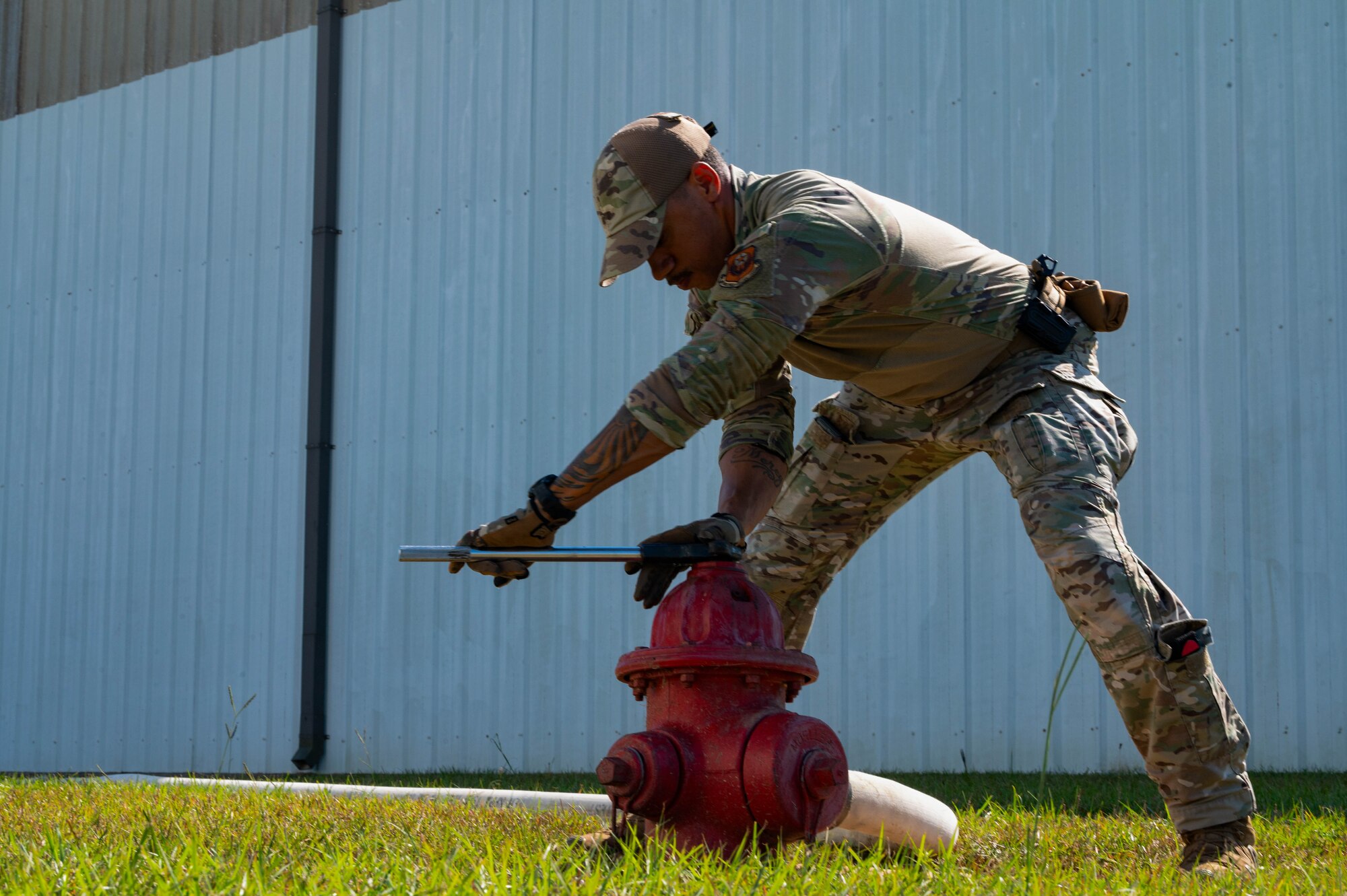 A U.S. Airman assigned to the 1st Special Operations Support Squadron mission sustainment team opens a valve on a fire hydrant during a validation exercise at Trent Lott International Airport in Moss Point, Mississippi, Oct. 25, 2024.