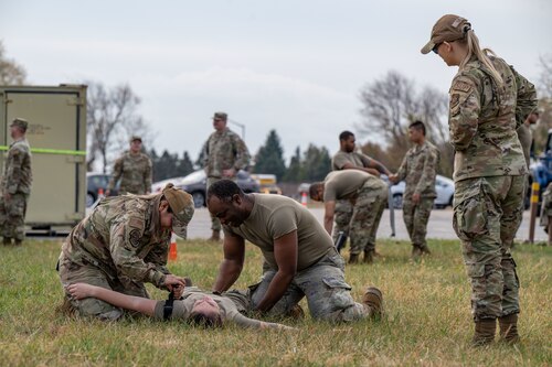 U.S. Air Force Senior Airman Zoey Baylor, right, 436th Logistics Readiness Squadron warehouse operations apprentice, supervises a team of Airmen performing Tactical Combat Casualty Care procedures during the LRS Mission Ready Airman Rodeo at Dover Air Force Base, Delaware, Nov. 7, 2024. The Rodeo consisted of three events intended to prepare Airmen for the future fight and meet MRA qualifications in a competitive, engaging and safe competition. (U.S. Air Force photo by Senior Airman Amanda Jett)