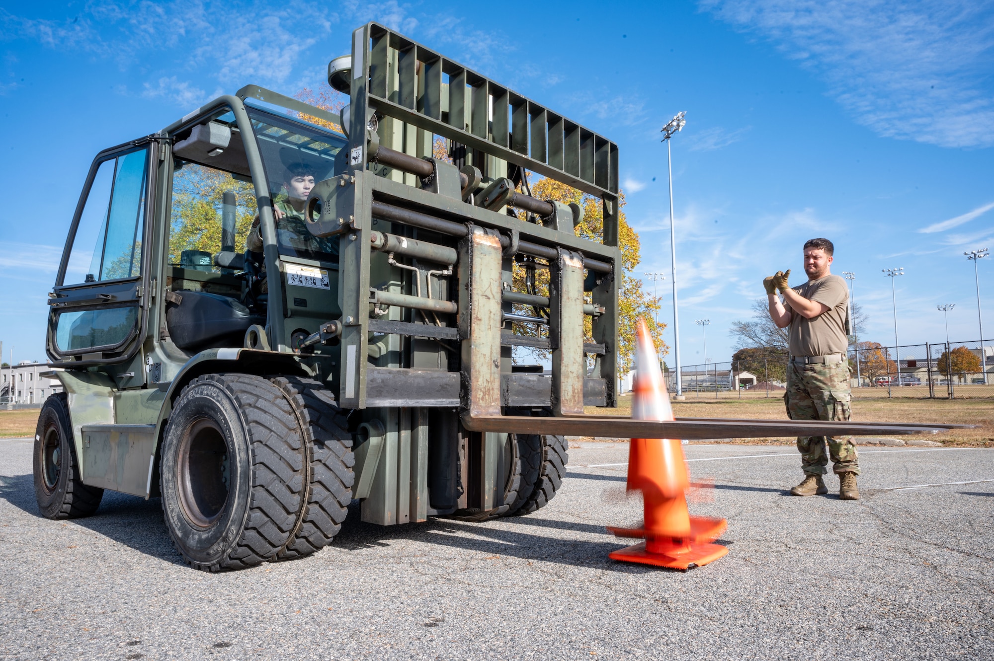 U.S. Air Force Senior Airman Joseph Gilmour, right, 436th Logistics Readiness Squadron ground transportation operator, directs a forklift during the LRS Mission Ready Airman Rodeo at Dover Air Force Base, Delaware, Nov. 7, 2024. The Rodeo consisted of three events intended to prepare Airmen for the future fight and meet MRA qualifications in a competitive, engaging and safe competition. (U.S. Air Force photo by Senior Airman Amanda Jett)