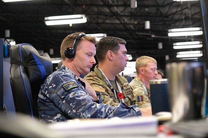 uniformed military members working at computers