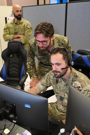 uniformed military members working at computers