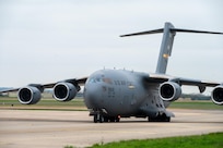 A C-17 Globemaster III aircraft assigned to Joint Base Charleston, South Carolina, taxis down the flightline
