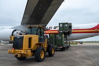 A 10K all terrain forklift prepares to offload equipment