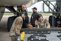 Airmen assigned to the 420th Air Base Squadron and 496th Air Base Squadron guide cargo off of a Kalitta Air Boeing 747