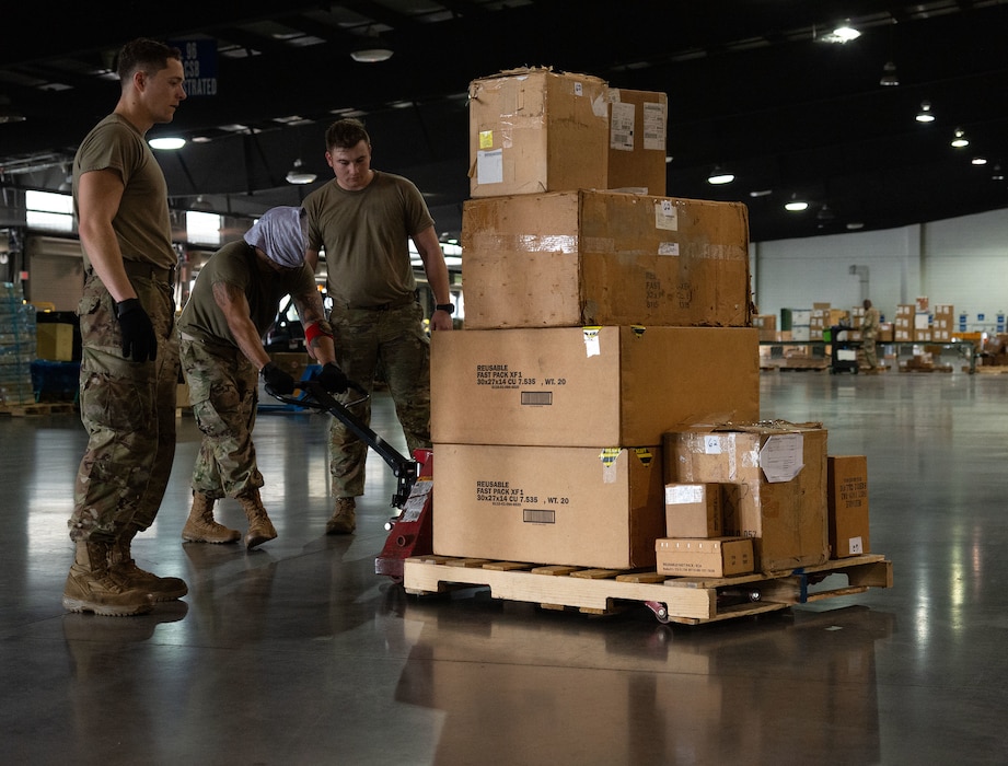 Team members of the 436th Aircraft Maintenance Squadron participate in a “Cargo Moves” course challenge requiring giving directions to a blindfolded team member at Dover Air Force Base, Delaware, Nov. 7, 2024. The base hosted Wing Readiness Week consisting of events spread over three days that focused on strengthening readiness, resilience and team cohesion with events throughout the base. (U.S. Air Force photo by Roland Balik)