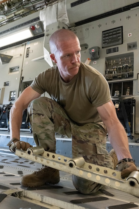 Master Sgt. Sean Hopkins, 436th Aircraft Maintenance Squadron production superintendent, flips rollers on a C-17 Globemaster III during the 2024 Wing Readiness Week at Dover Air Force Base, Delaware, Nov. 6, 2024. Teams from various squadrons across the 436th Airlift WIng faced off in challenges designed to test their operational skills while emphasizing versatility and the ability to fill roles outside of normal duties. (U.S. Air Force photo by Mauricio Campino)