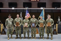 Men in U.S. Army uniforms at awards ceremony.