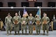 Men in U.S. Army uniforms at awards ceremony.