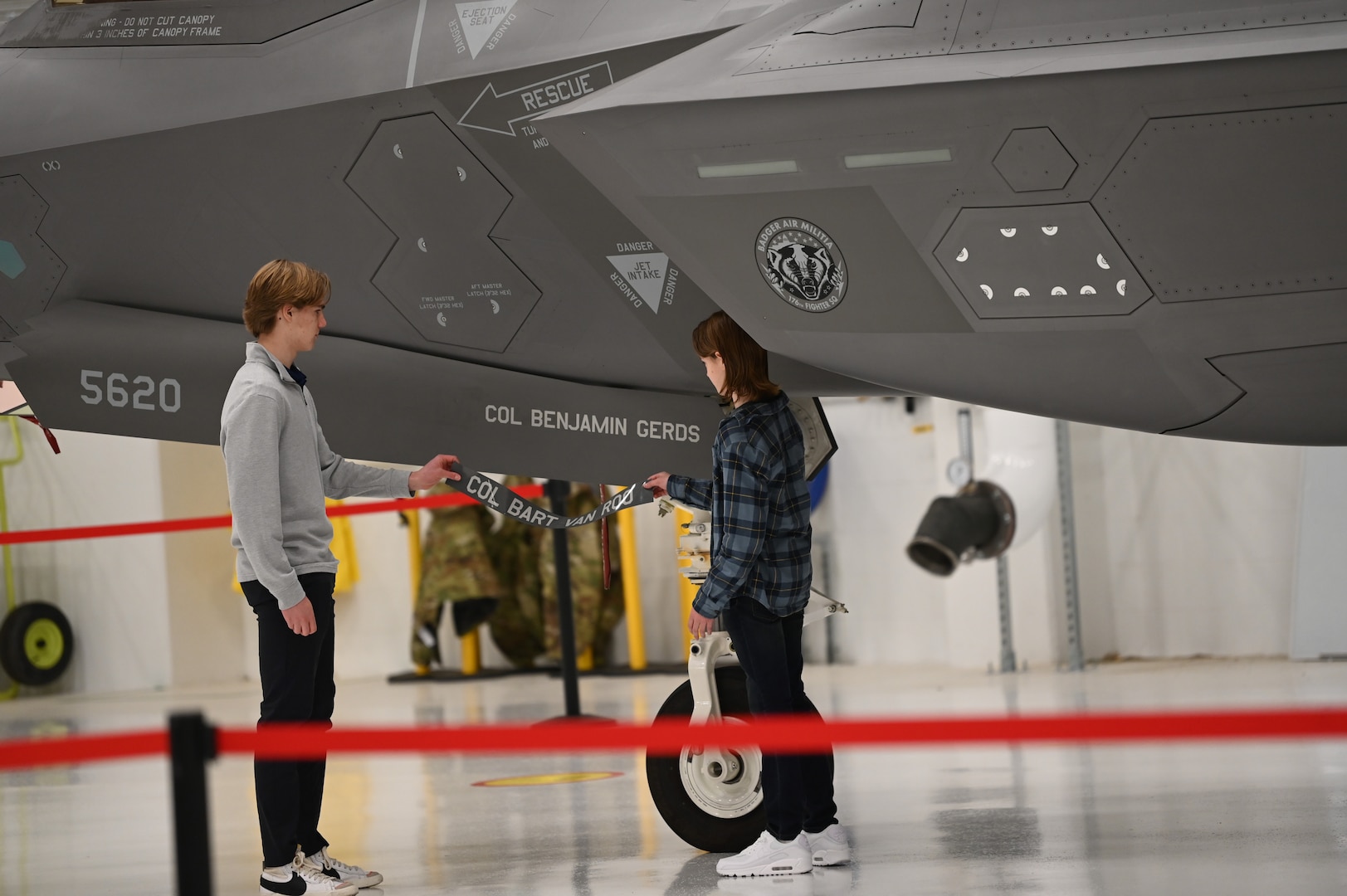 Children of U.S. Air Force Col. Benjamin Gerds, the 115th
Fighter Wing commander, reveal his newly painted name on the
commander’s jet in a hangar at Truax Field in Madison, Wisconsin,
Nov. 3, 2024. The wing held its change of command
ceremony on base over a regularly scheduled drill weekend. (U.S.
Air National Guard photo by Master Sgt. Mary Greenwood)