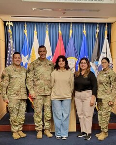Pfc. Anamaris Irizarry Torres, center, with her father, Maj. Cesar Irizarry, second from left; mother, Nydia Torres, second from right; Recruiting and Retention Command Sgt. Maj. Kevin Ortiz, left; and Master Sgt. Leydanil Robles, right, Recruiting and Retention, A Company Operations NCO, following Irizarry's recruitment.