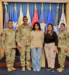 Pfc. Anamaris Irizarry Torres, center, with her father, Maj. Cesar Irizarry, second from left; mother, Nydia Torres, second from right; Recruiting and Retention Command Sgt. Maj. Kevin Ortiz, left; and Master Sgt. Leydanil Robles, right, Recruiting and Retention, A Company Operations NCO, following Irizarry's recruitment.