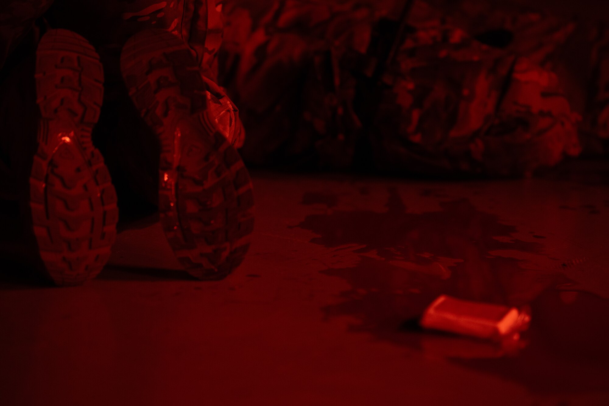A U.S. Air Commando, contestant of the Service Member of the Year competition, kneels next to a simulated wounded Airman to perform Tactical Combat Casualty Care at Hurlburt Field, Florida, Oct. 30, 2024.