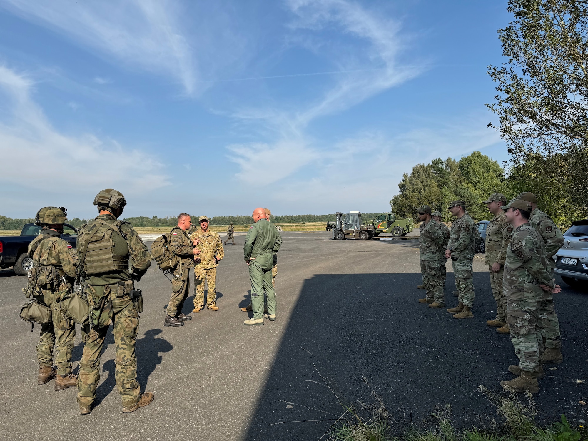 U.S. Air Force Senior Airman Anthony Skalski, center, a Polish translator with the 39th Operations Support Squadron at Incirlik Air Base, Türkiye, speaks with Polish Air Force Byliniak, second from left, during exercise Agile Bison 2024 at Koszalin, Poland, Sept. 18, 2024. Skalski provided translation services during the exercise, a bilateral training event designed to enhance interoperability, maintain joint readiness, and strengthen rapid response capabilities between U.S. and Polish air forces. (Courtesy photo)