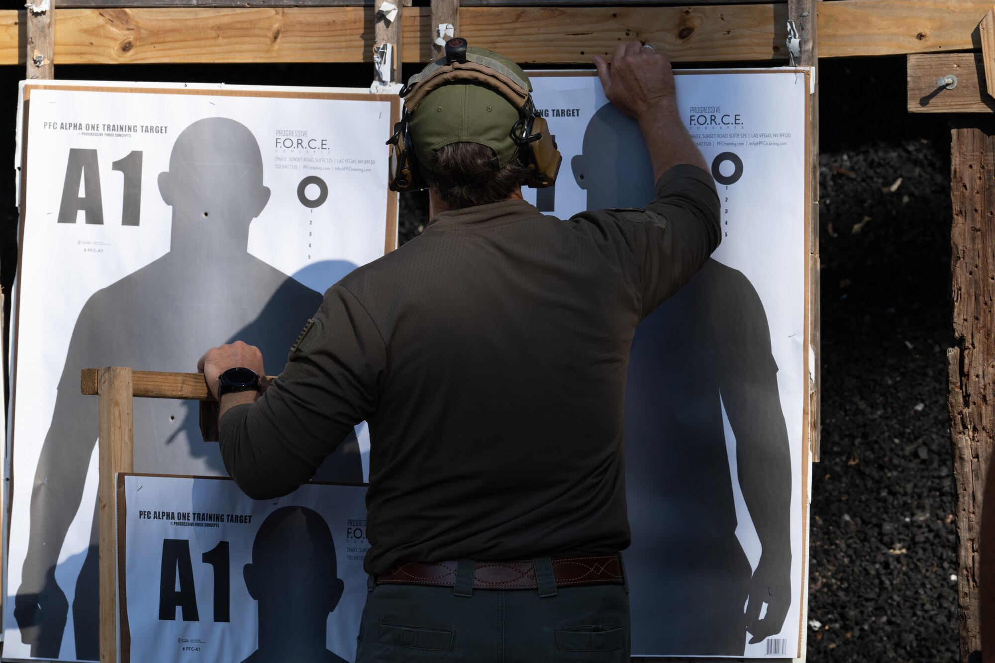 A score proctor for the Service Member of the Year competition hangs up targets at Hurlburt Field, Florida, Oct. 29, 2024.
