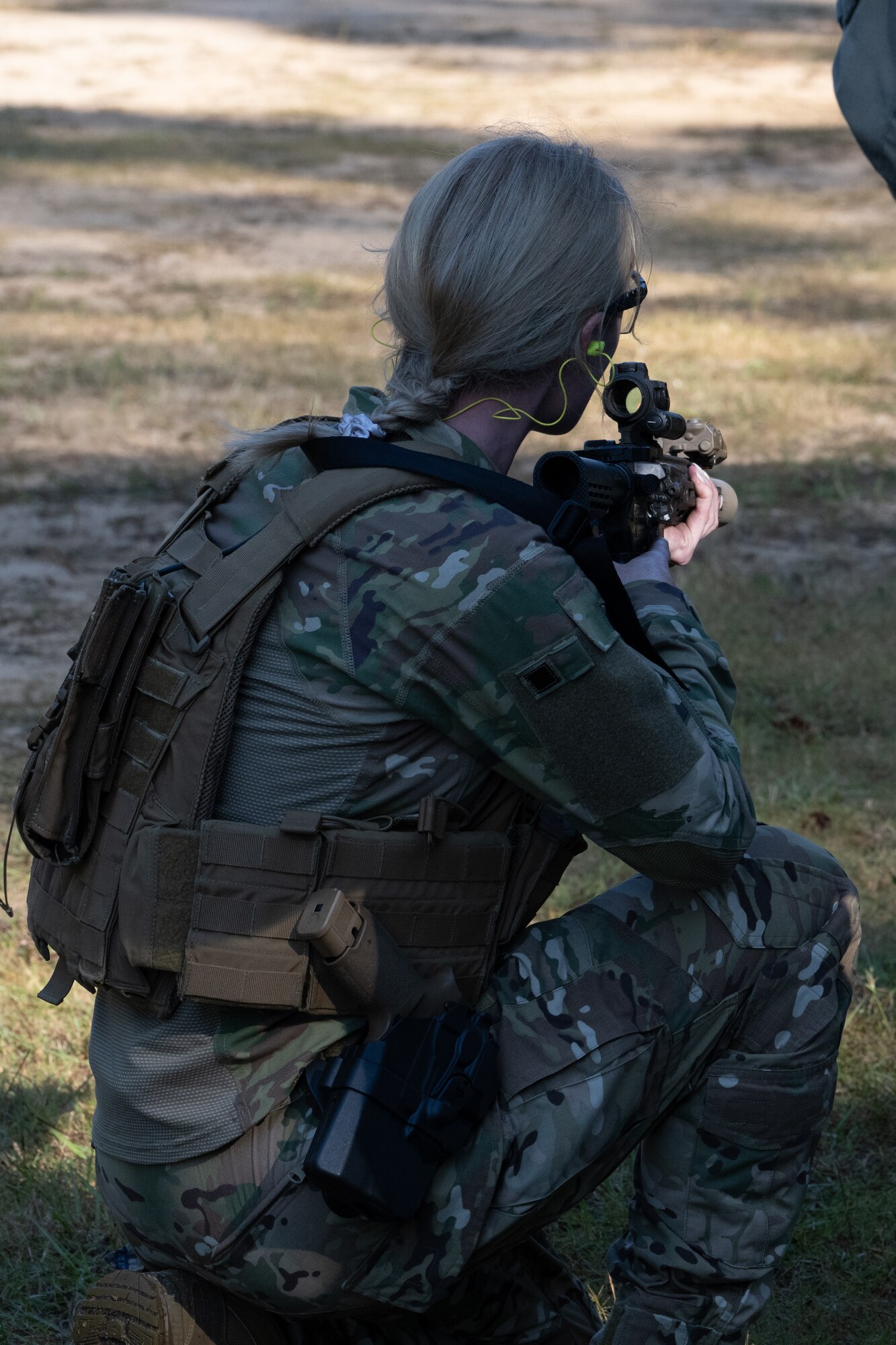 A U.S. Air Commando, a contestant for the Service Member of the Year competition, crouches with a rifle at Hurlburt Field, Florida, Oct. 29, 2024.
