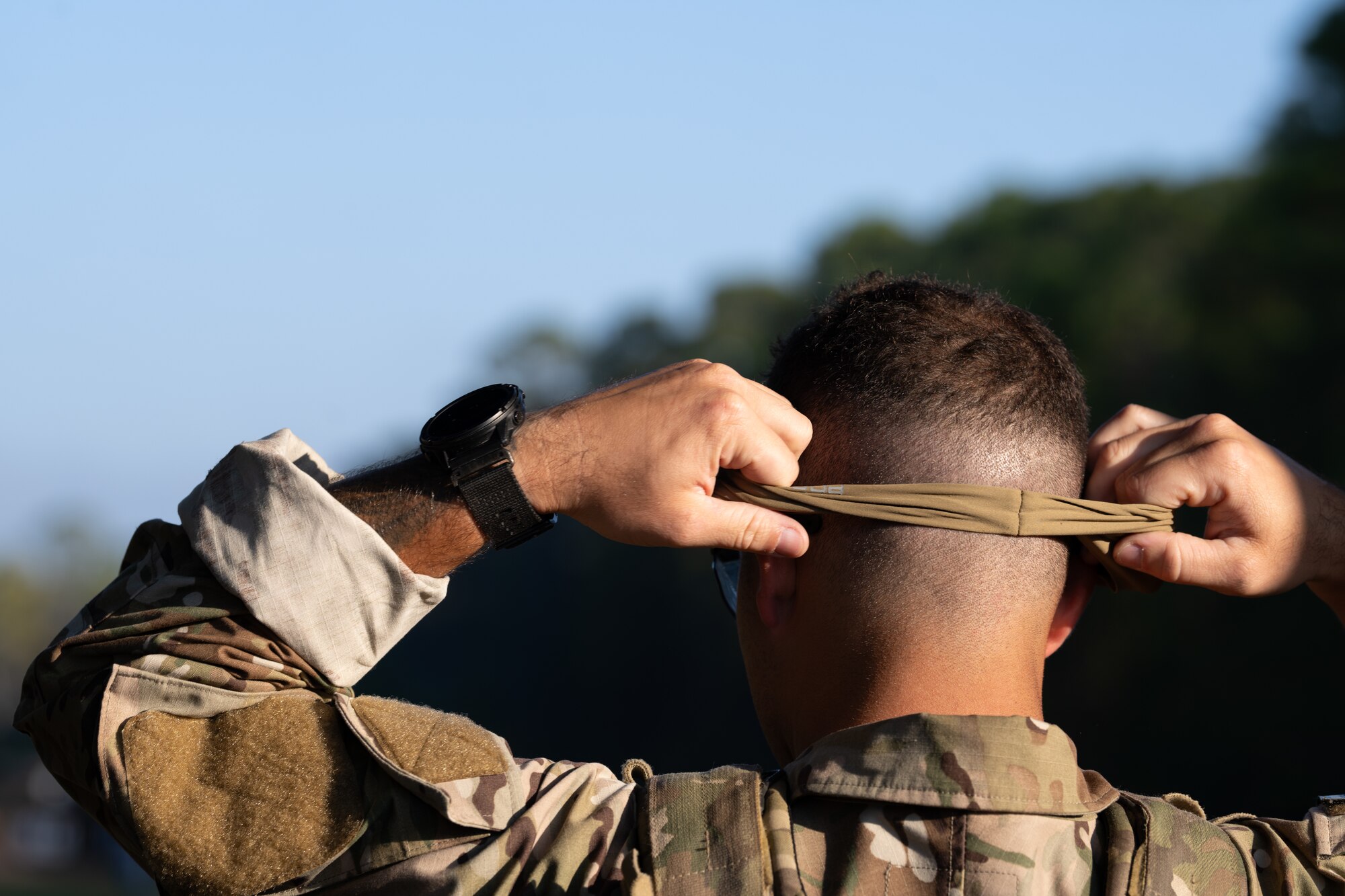 A U.S. Air Commando, a contestant for the Service Member of the Year competition, puts on a face cover at Hurlburt Field, Florida, Oct. 29, 2024.