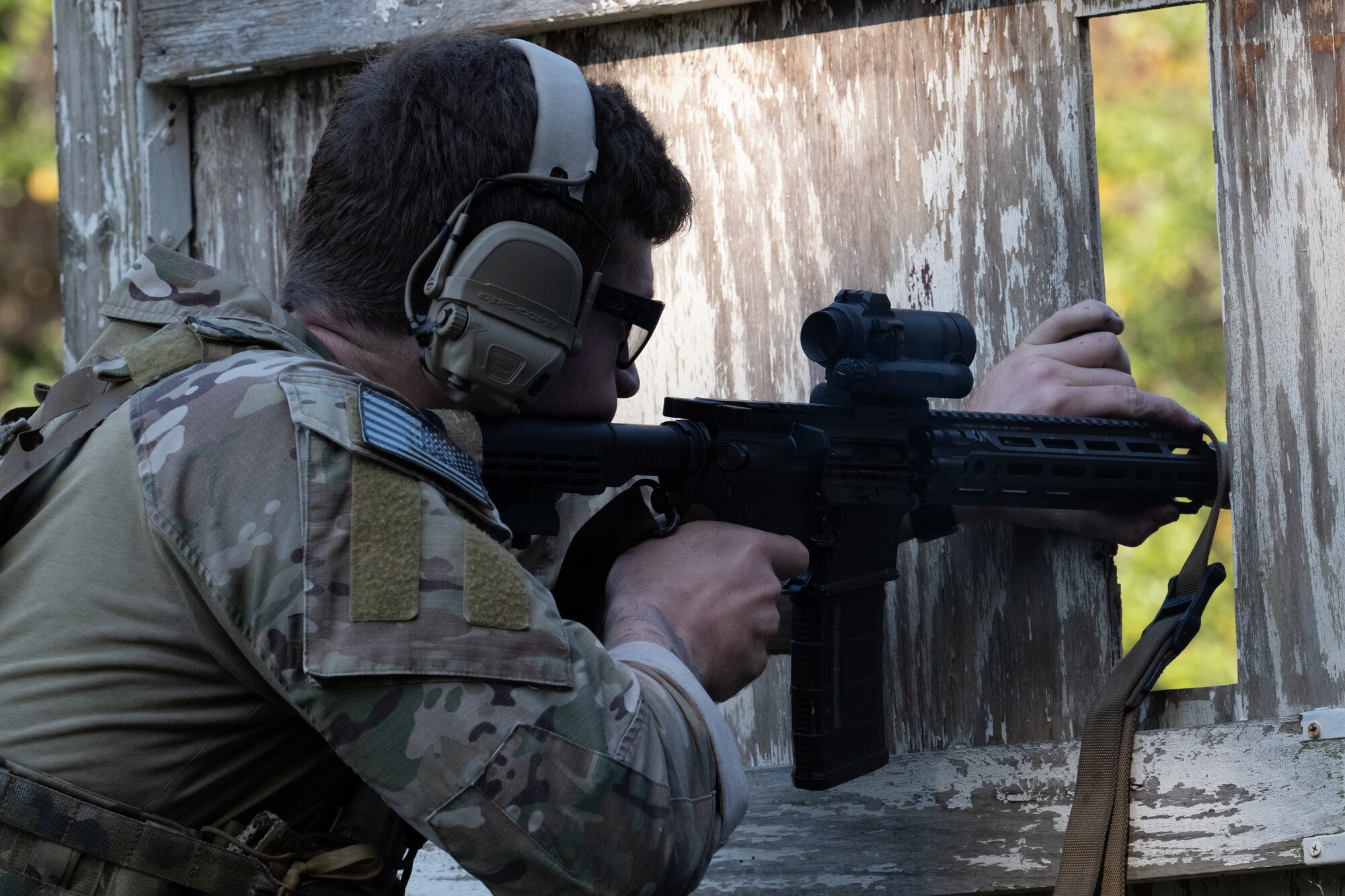 A U.S. Air Commando, a contestant of the Service Member of the Year competition, aims through a makeshift window at Hurlburt Field, Florida, Oct. 29, 2024.