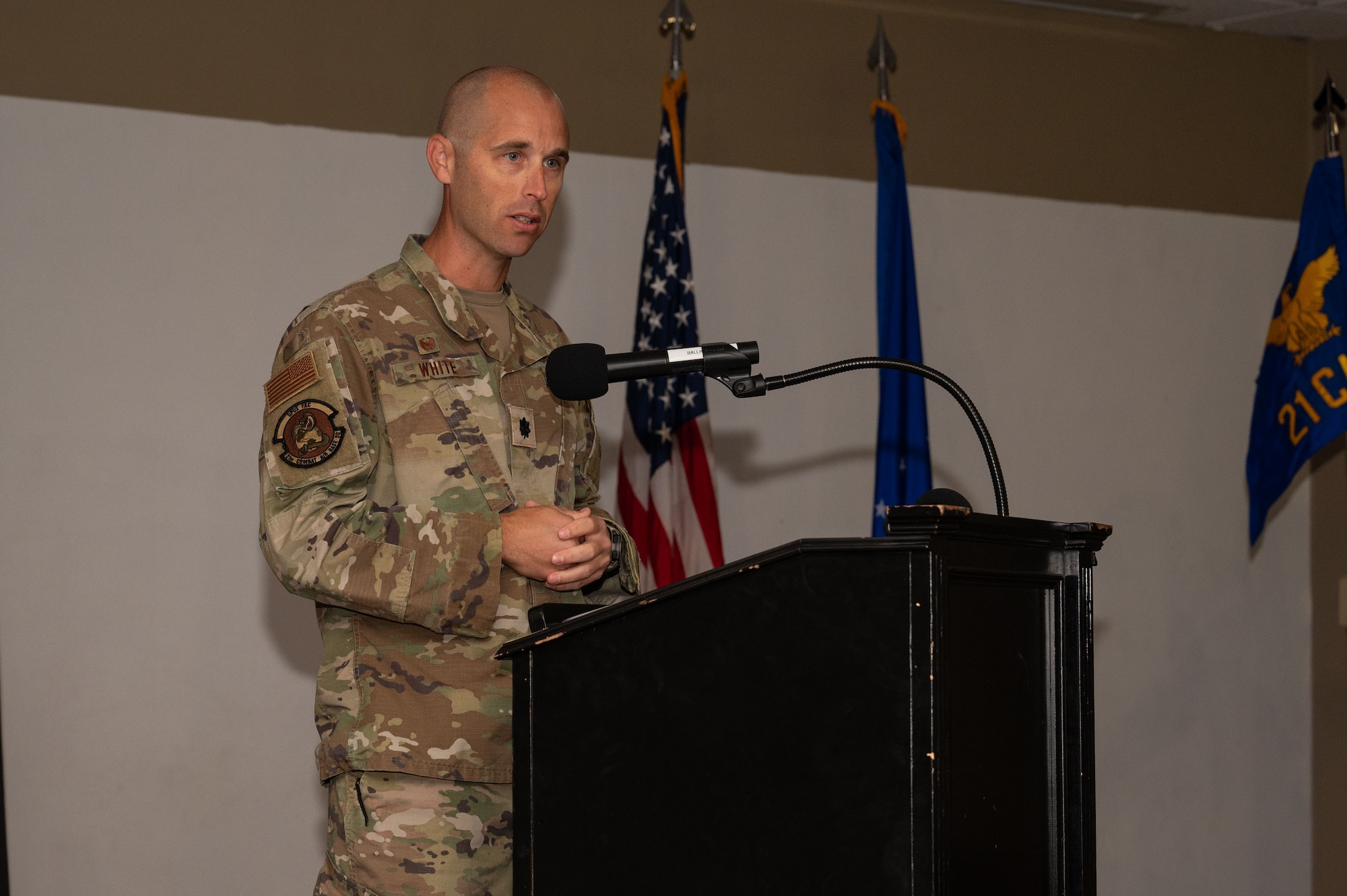 U.S. Air Force Lt. Col. Nathaniel White, 21st Combat Air Base Squadron commander, speaks during the 21st CABS assumption of command at Dyess Air Force Base, Texas, Nov. 7, 2024. Each Airman assigned to the 21st Air Task Force and CABS will complete the Air Force Force Generation cycle, which includes the reset, prepare, certify, and available phases, ensuring time for training and team cohesion before deployment. (U.S. Air Force photo by Airman 1st Class Emma Anderson)