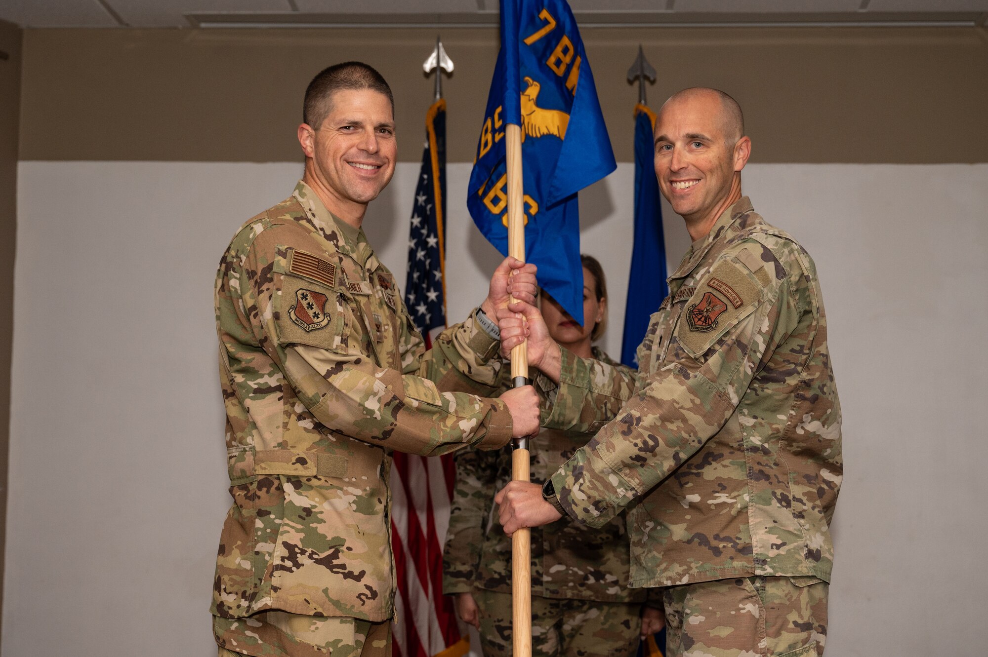 U.S. Air Force Col. Seth Spanier, 7th Bomb Wing commander, passes the guidon to Lt. Col. Nathaniel White, 21st Combat Air Base Squadron commander, during the 21st CABS assumption of command at Dyess Air Force Base, Texas, Nov. 7, 2024. Together, the 21st Air Task Force and 21st CABS will train and prepare to execute Agile Combat Employment to further the evolution of airpower in deployed locations world-wide. (U.S. Air Force photo by Airman 1st Class Emma Anderson)