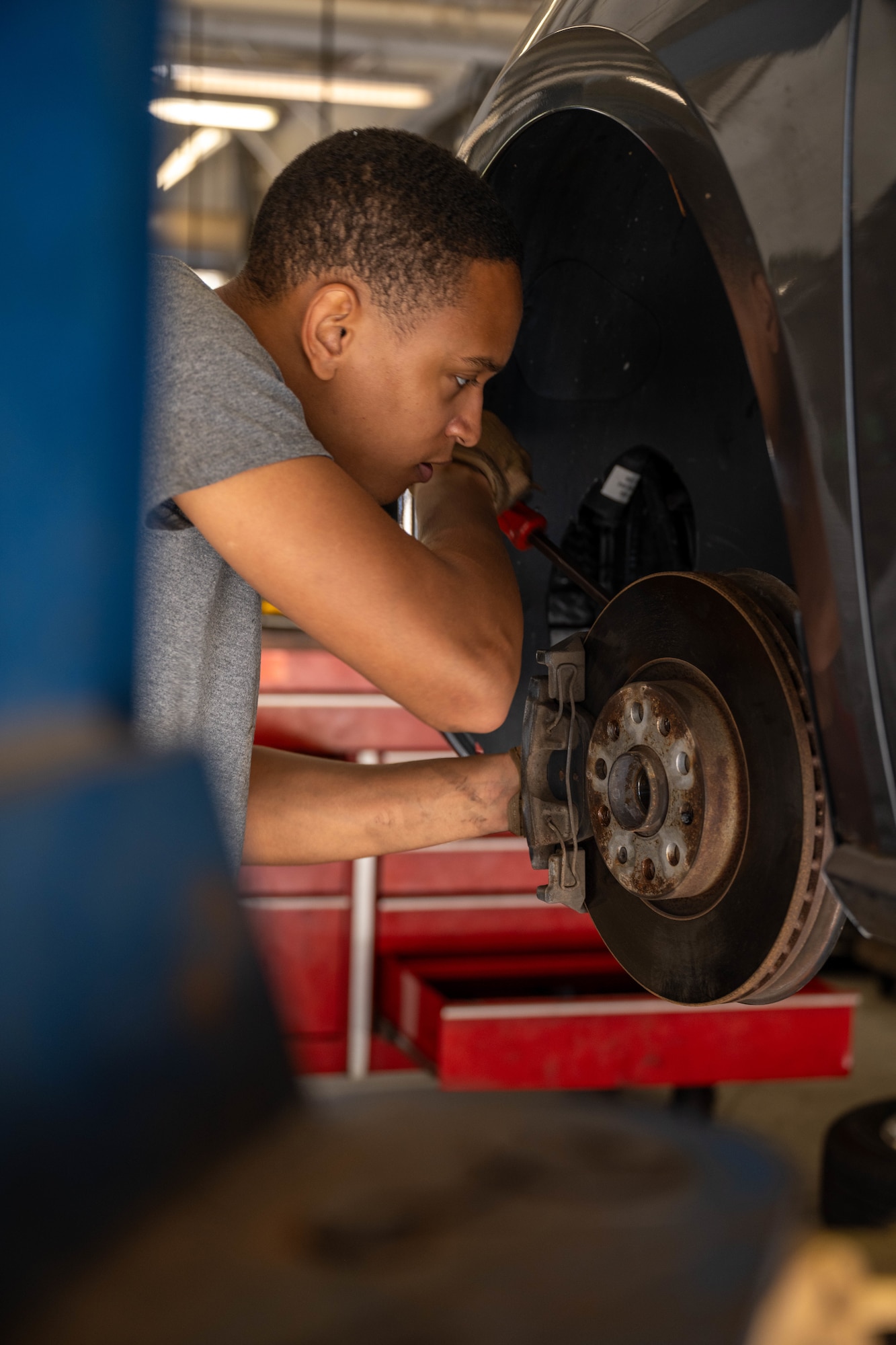 A U.S. Air Force Staff Sgt., repeat Auto Hobby Shop customer, repairs the anti-lock brake sensor on his car at Hurlburt Field, Florida, Oct. 29, 2024.
