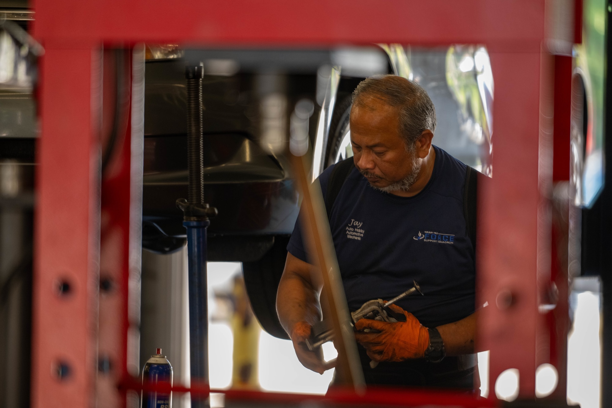 Jay Quitugua, 1st Special Operations Force Support Squadron Auto Hobby automotive mechanic, holds a C-clamp at Hurlburt Field, Florida, Oct. 29, 2024.