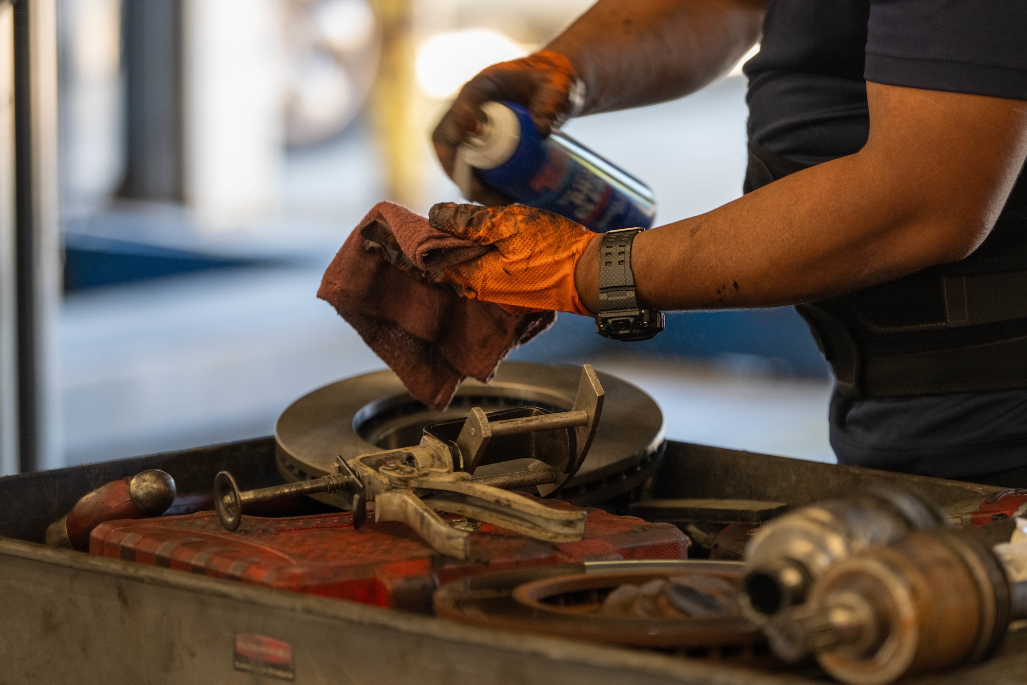 Jay Quitugua, 1st Special Operations Force Support Squadron Auto Hobby automotive mechanic, sprays brake cleaner into a rag at Hurlburt Field, Florida, Oct. 29, 2024.