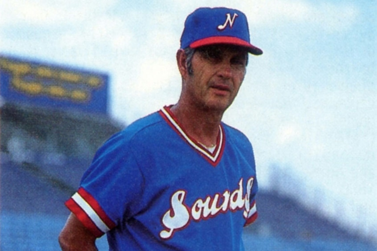 A baseball player poses for a photo.