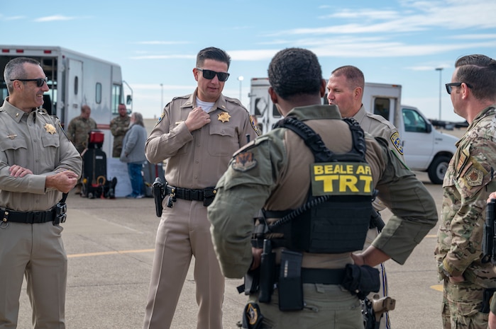U.S. Air Force Airmen from the 9th Security Forces Squadron talk with Auburn California Highway Patrol (CHP) officers on Beale Air Force Base, California, Oct. 30, 2024.
