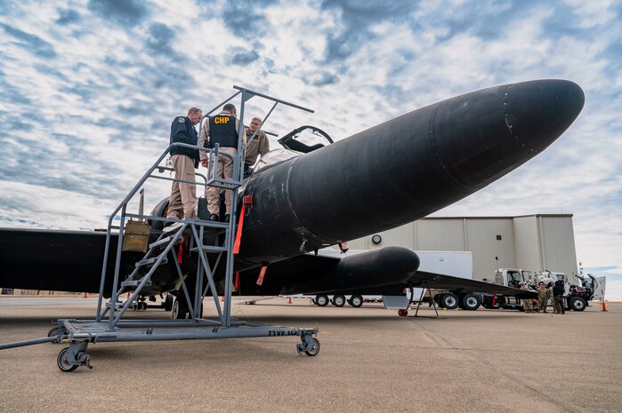 U.S. Air Force Staff Sgt. Braydon Campbell, 9th Aircraft Maintenance Squadron U-2 dedicated crew chief, shows the inside of a U-2 Dragon Lady cockpit to two Auburn California Highway Patrol (CHP) officers on Beale Air Force Base, California, Oct. 30, 2024.