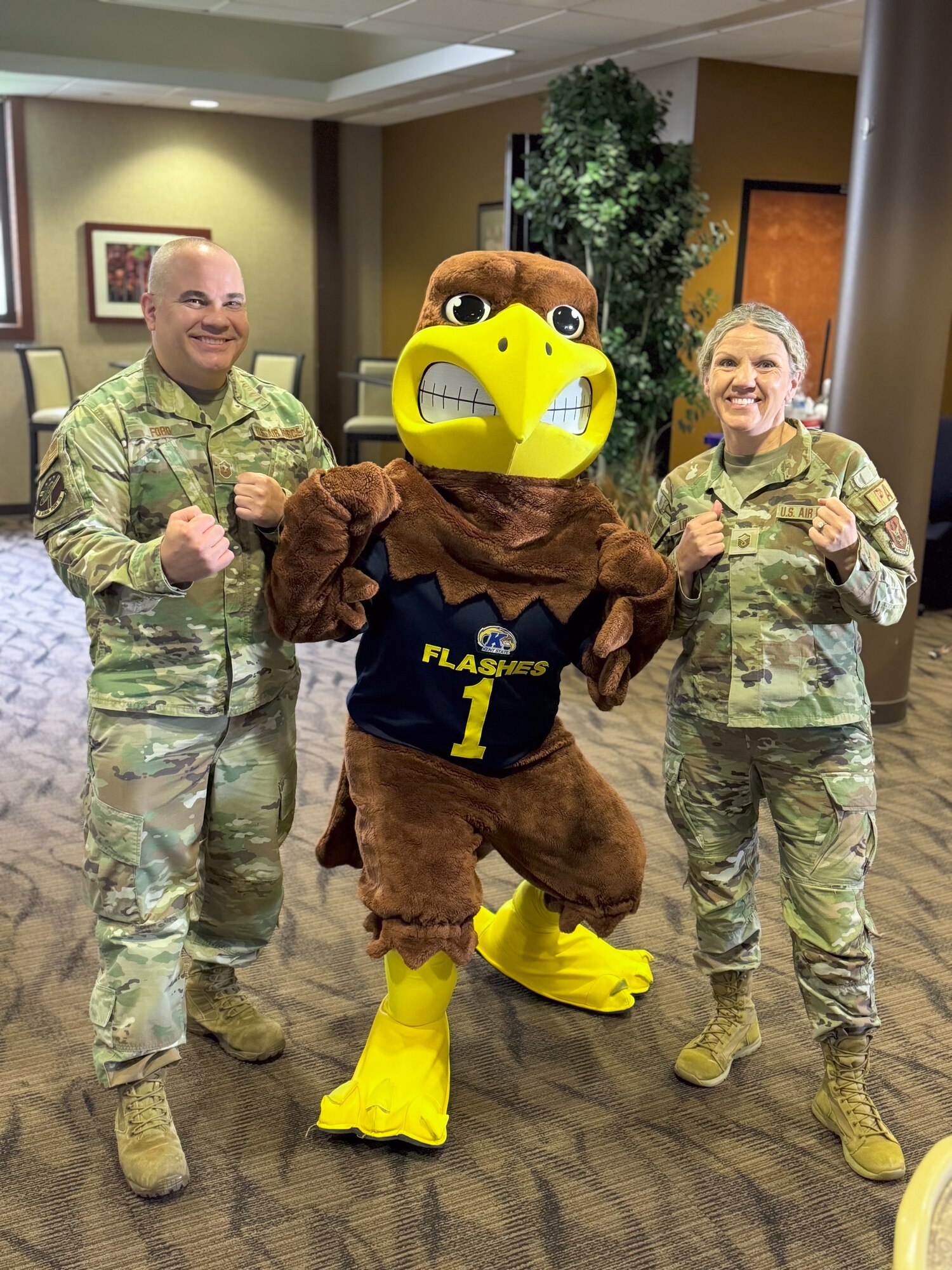 Citizen Airmen from the 910th Airlift Wing pose for a photo with Golden Flash, the mascot of Kent State University at Youngstown Air Reserve Station, Ohio, Nov. 2, 2024.
