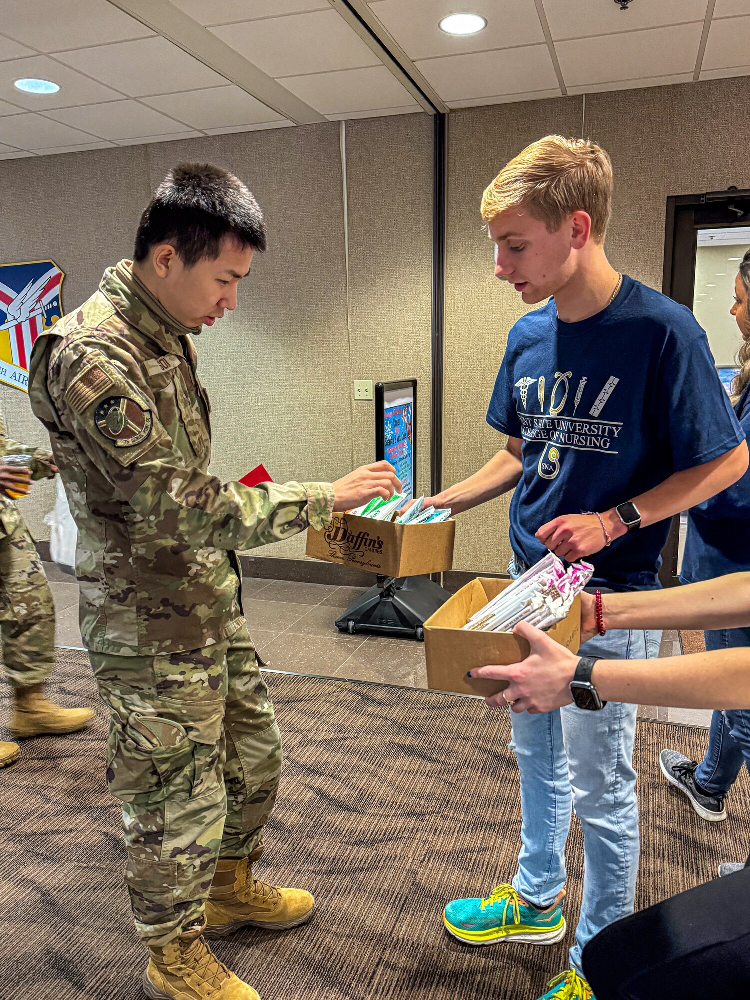 A nursing student from Kent State University Trumbull Campus hands out a candy bar to a Citizen Airman from the 910th Airlift Wing at Youngstown Air Reserve Station, Ohio, Nov. 2, 2024.