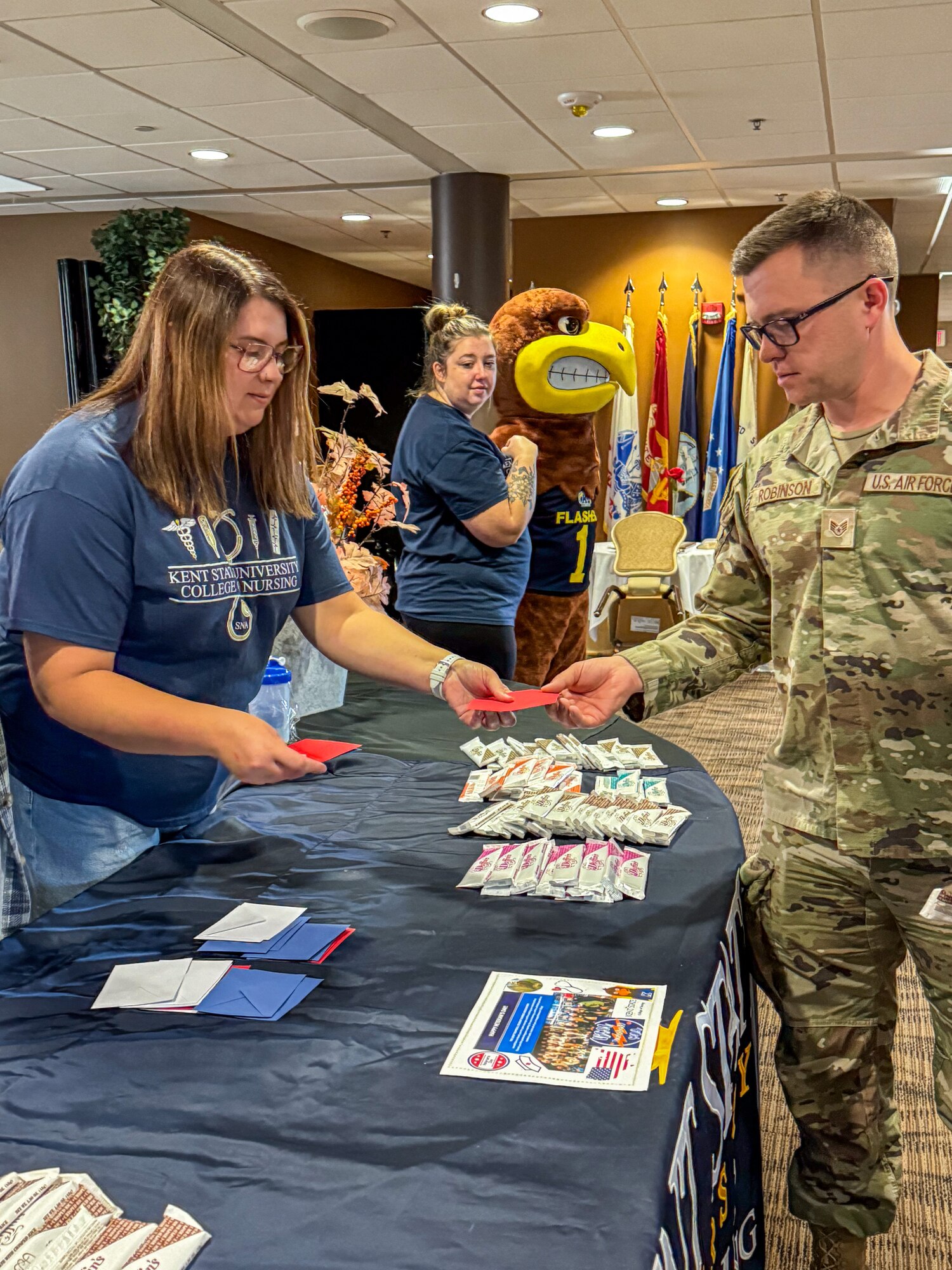 A nursing student from Kent State University Trumbull Campus hands out a candy bar to a Citizen Airman from the 910th Airlift Wing at Youngstown Air Reserve Station, Ohio, Nov. 2, 2024.